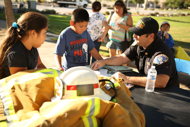 Family Reading Rally September 19, 2015 - Fireman reads to the children.